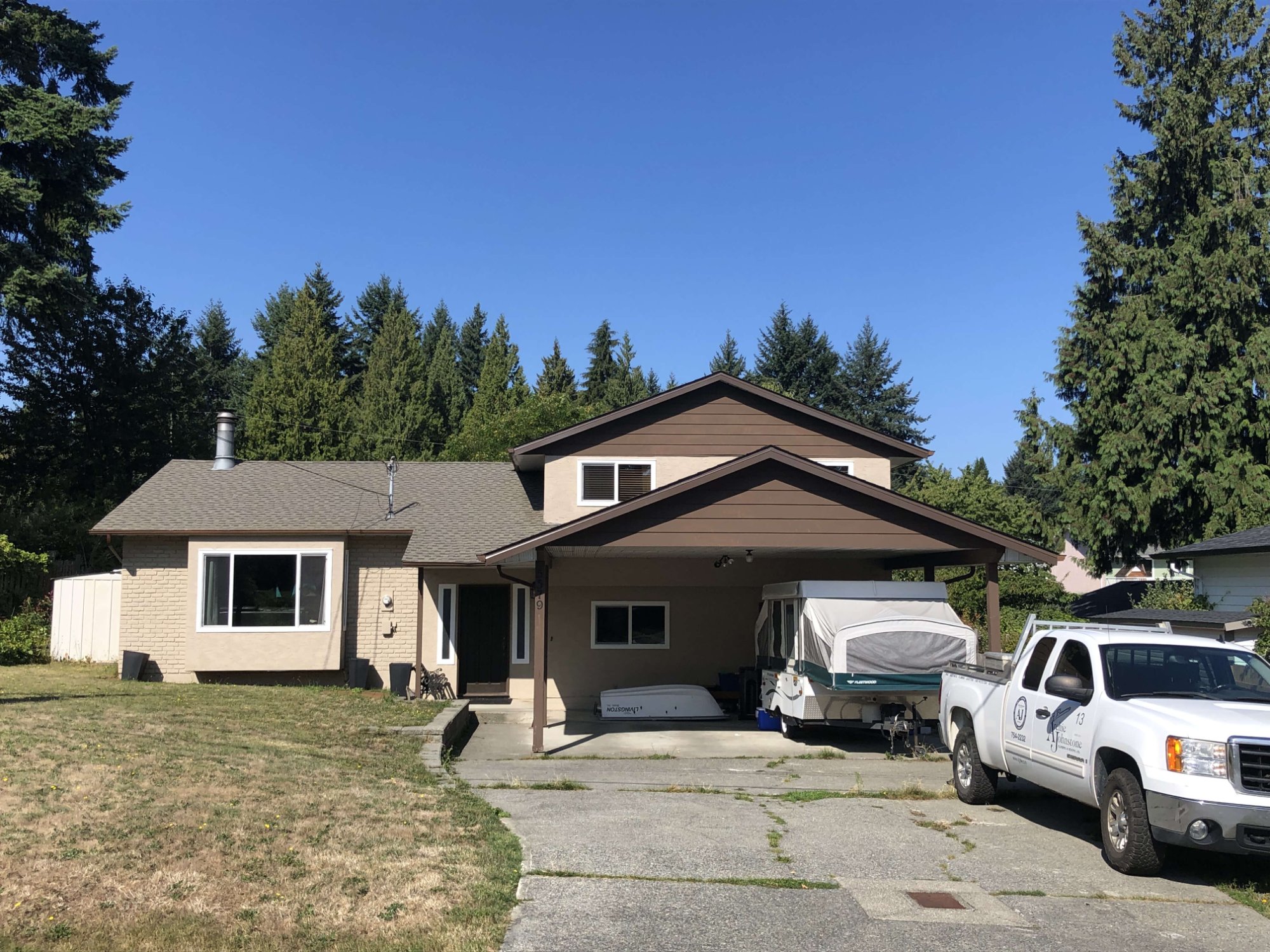 Shift crew installing asphalt shingles on a Vancouver Island home